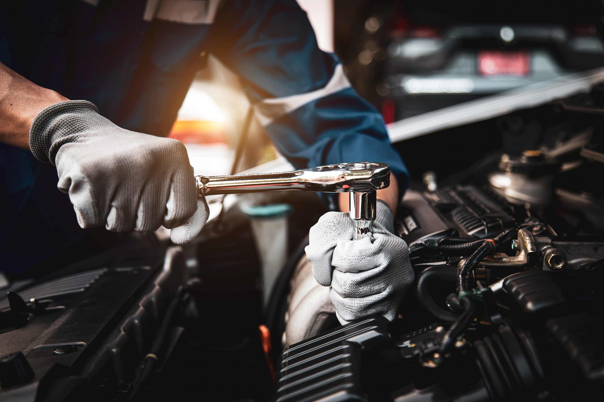 Man doing repairs on car.