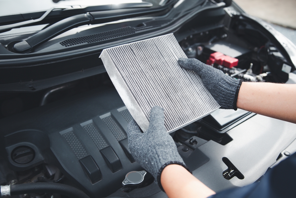 Mechanic checking car air conditioning system at Nork Motors